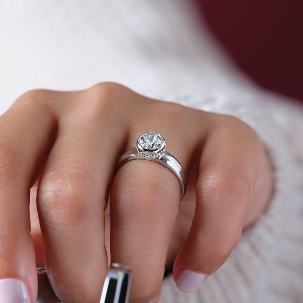 Hand with a diamond ring on a guitar, blurred background hidden halo